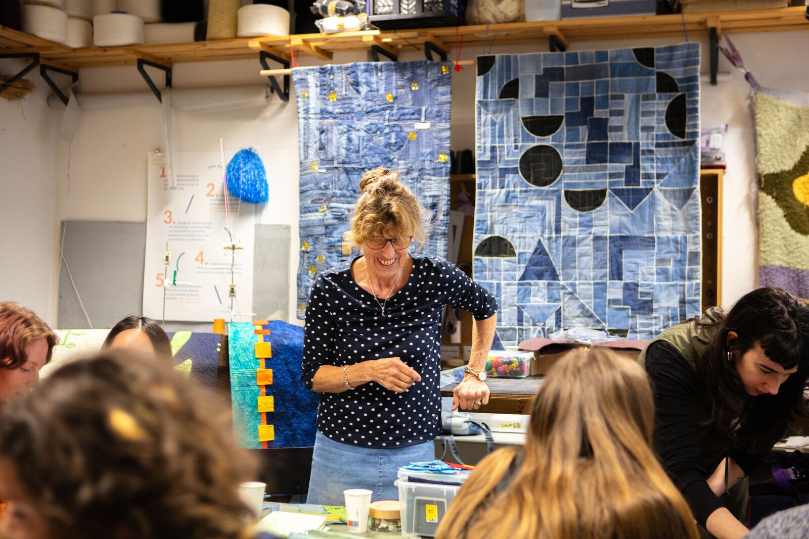 Heike Rosenbaum, one of the workshop's quilters, laughing while demonstrating a technique.