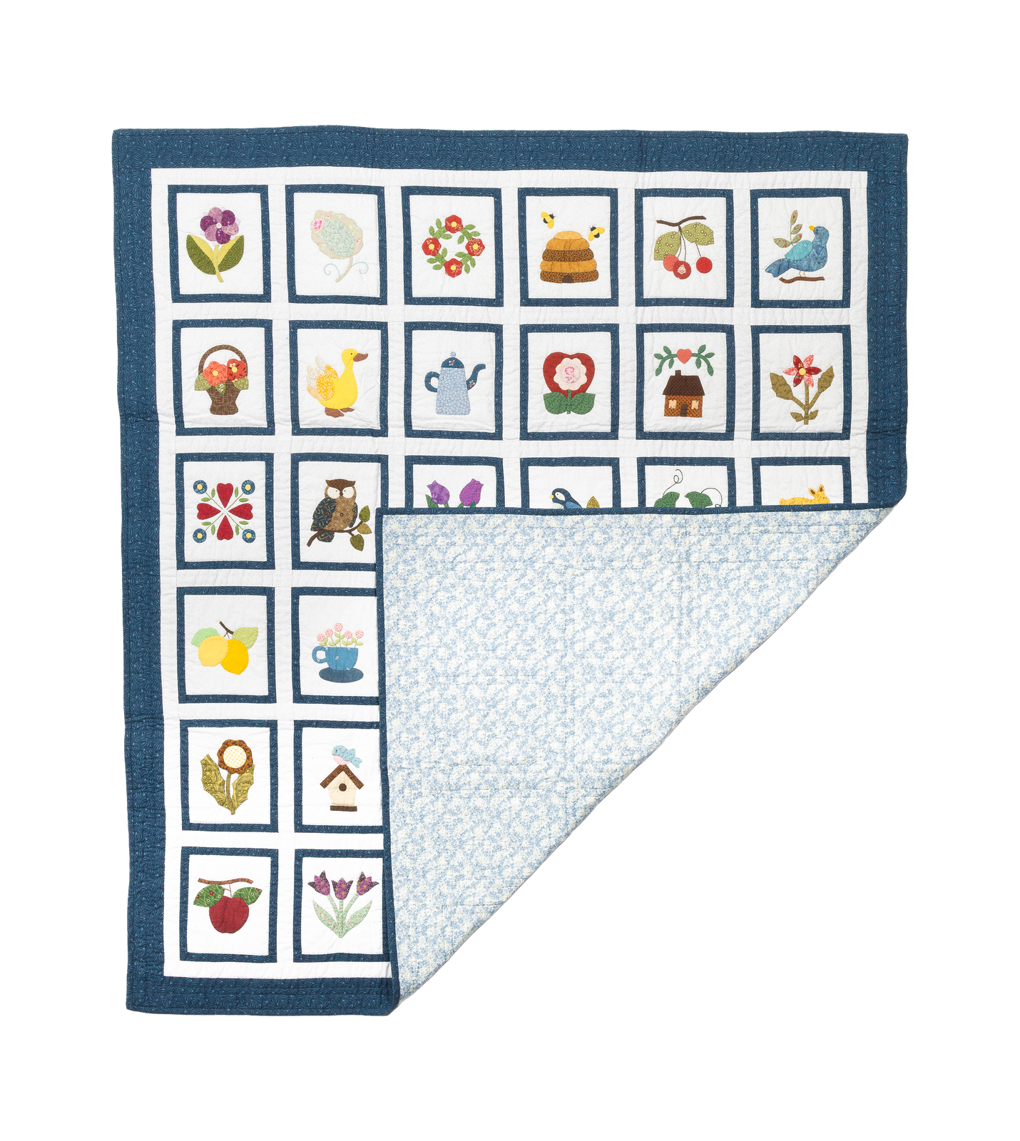 Patchwork Pantry, a quilt of small framed appliqué motifs: flowers, birds, fruit and teacups.