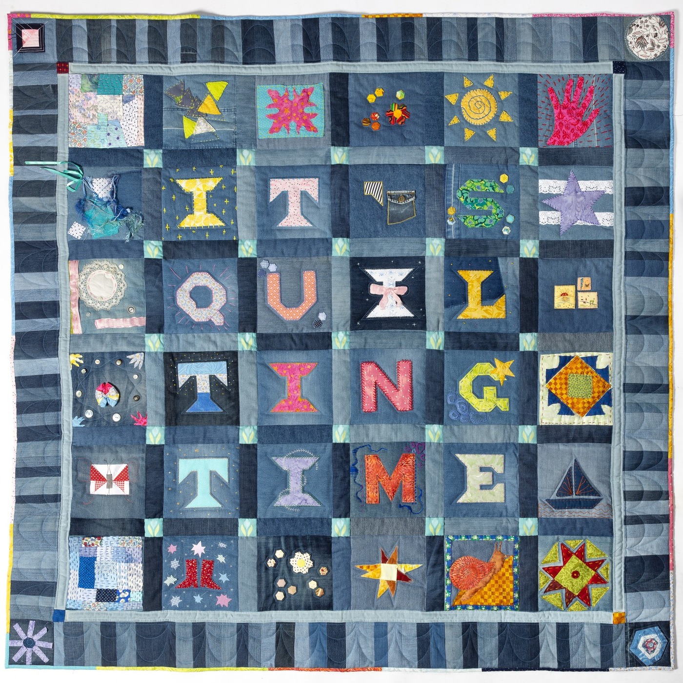 The same blocks now sashed, bordered and quilted into one finished community quilt spelling It's Quilting Time.